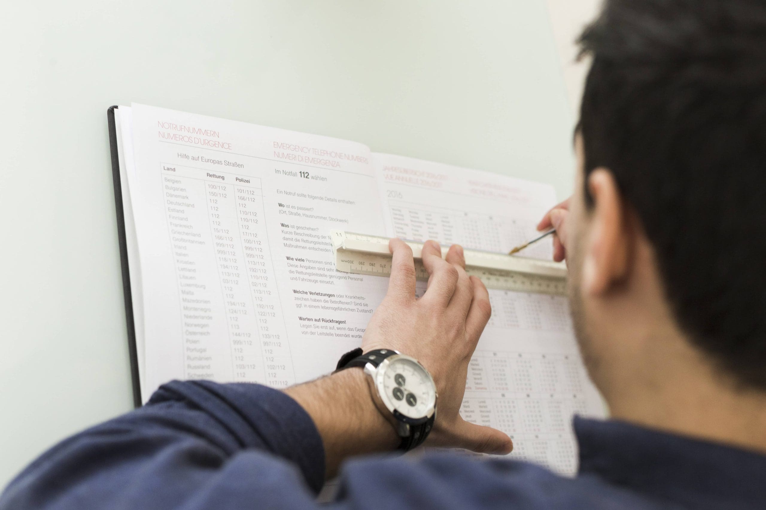 man-underlining-data-notebook