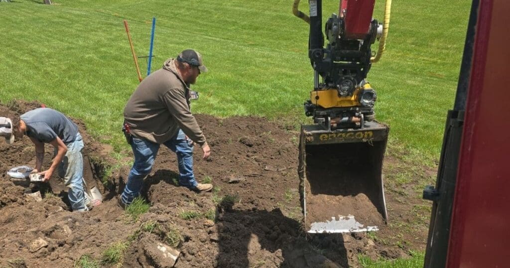 workers-digging-soil-using-excavating-equipment