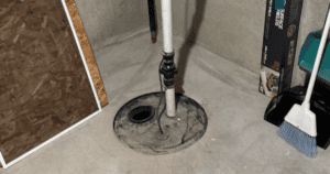 sump pump installed in a pit in a basement floor
