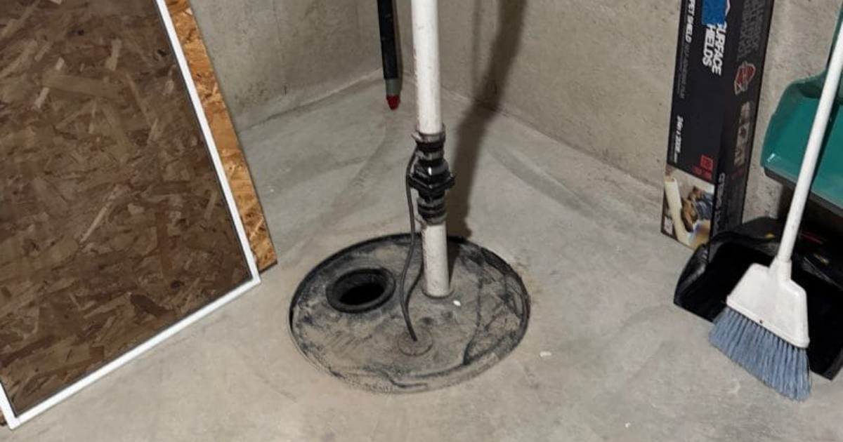 sump pump installed in a pit in a basement floor