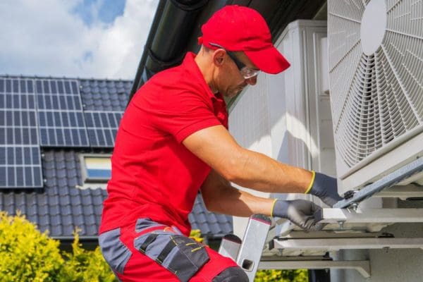 a-technician-performing-maintenance-on-an-HVAC-system
